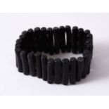 A BLACK CORAL BRACELET, open approx. 7cm diameter.