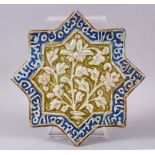 A SELJUK KASHAN STAR SHAPED POTTERY TILE, possibly 13th century, the central panel moulded with