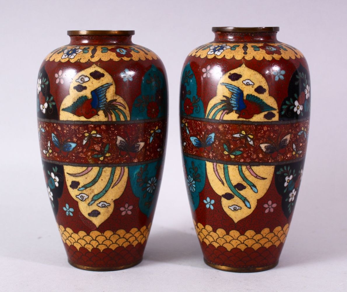 A PAIR 20TH CENTURY JAPANESE CLOISONNE VASES, red ground with panels of birds and flowers, 15cm