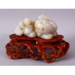 A GOOD CHINESE CARVED WHITE JADE FIGURE OF THREE LION & BOXWOOD STAND, one larger dog with two young