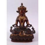 A CHINESE GILT BRONZE INLAID FIGURE OF A DEITY / BUDDHA, in a seated position with an object in