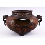 A CHINESE 19TH / 20TH CENTURY GILT BRONZE TWIN HANDLE CENSER, the censer with open sides, with