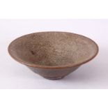 A CHINESE CIRCULAR TEA BOWL, with brown textured glaze, 13.5cm.