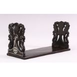 A CEYLONESE EBONY FOLDING BOOK STAND, with carved bone inlaid decoration, 35cm long.
