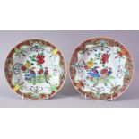 A GOOD PAIR OF 18TH CENTURY CHINESE FAMILLE ROSE CIRCULAR PLATES, painted with flowers and peacocks,