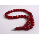 A CONTEMPORARY CHINESE CHERRY AMBER NECKLACE, approx. 40cm long.