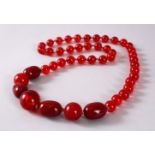 A GOOD SET OF CHERRY AMBER ROSARY BEAD NECKLACE, with graduating bead size, approx open size 84cm.