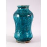 A 19TH CENTURY ISLAMIC MARKET DRUG JAR, with turquoise glazed decoration, 20cm high.