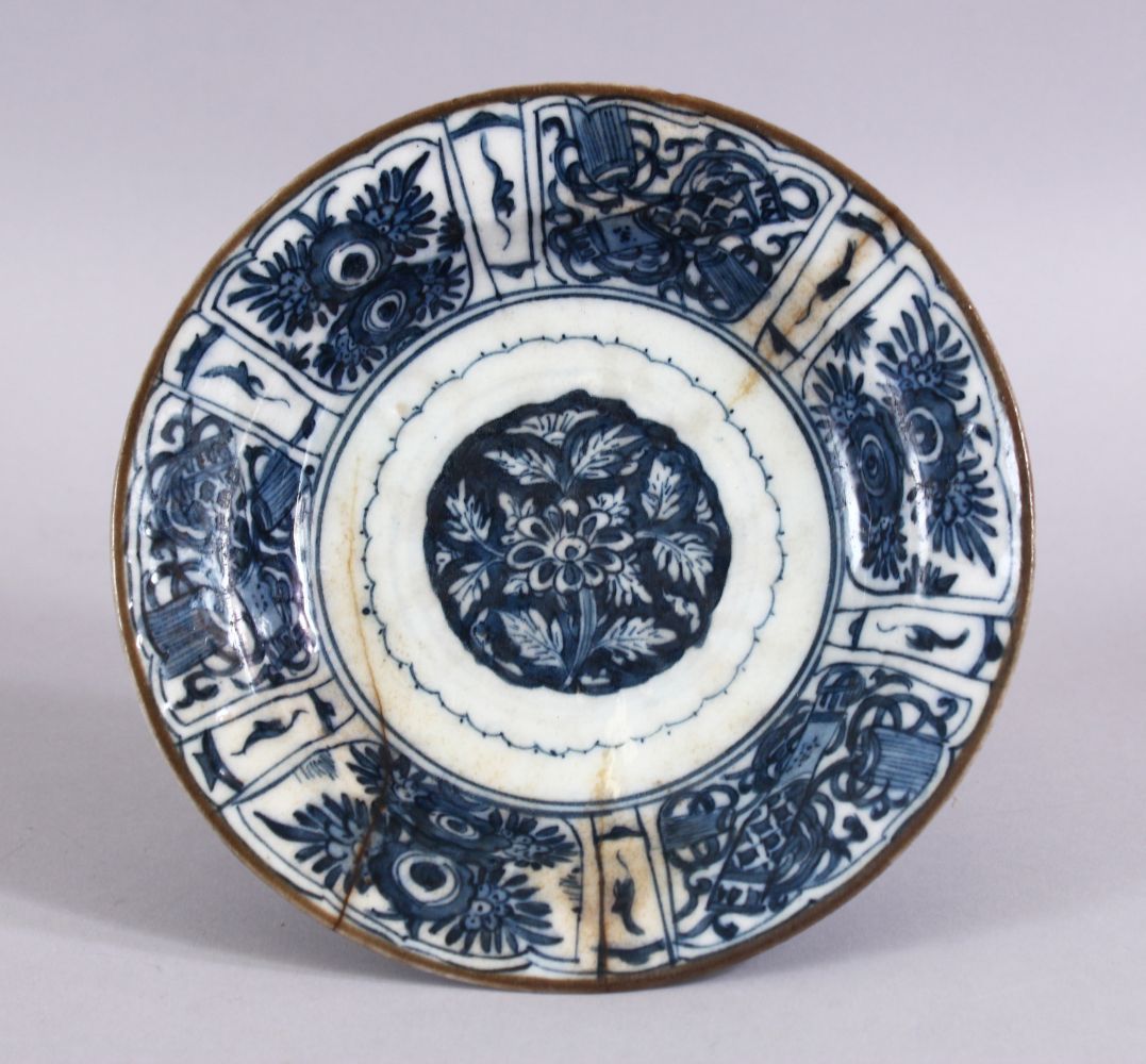 A 17TH CENTURY PERSIAN SAFAVID BLUE AND WHITE DISH, decorated with precious objects and native