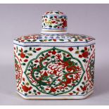 A CHINESE WUCAI DECORATED PORCELAIN TEA CADDY & COVER, decorated with panels of dragons and flora,