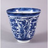A CHINESE KANGXI PERIOD BLUE & WHITE PORCELAIN WINE CUP, decorated with panels of native sprays of