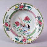 AN 18TH CENTURY CHINESE FAMILLE ROSE CIRCULAR PLATE, painted with flowers and birds, 23cm diameter.