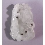 A CHINESE CARVED AND PIERCED JADE AMULET, carved with animal and fruit, 5cm x 3.5cm.