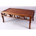A 19TH CENTURY CHINESE CARVED HARDWOOD OPIUM TABLE, with simplistically carved frieze stood upon