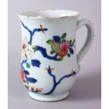 A 18TH/19TH CENTURY CHINESE FAMILLE ROSE FLORAL DECORATED TANKARD, with a ruyi handle, 12.5cm high.