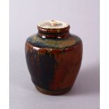 A JAPANESE MEIJI PERIOD POTTERY TEA CADDY / JAR AND IVORY COVER, with a drip glaze base and ivory