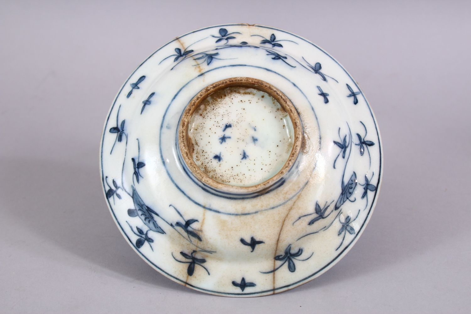 A 17TH CENTURY PERSIAN SAFAVID BLUE AND WHITE DISH, decorated with precious objects and native - Image 3 of 3