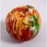 A CHINESE CARVED BAKELITE OR CHERRY AMBER ZODIAC BALL, carved with animals, 9cm diameter.