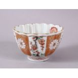 A CHINESE KANGXI PERIOD FAMILLE VERTE PORCELAIN FLUTED TEA BOWL, with decoration of prunus and