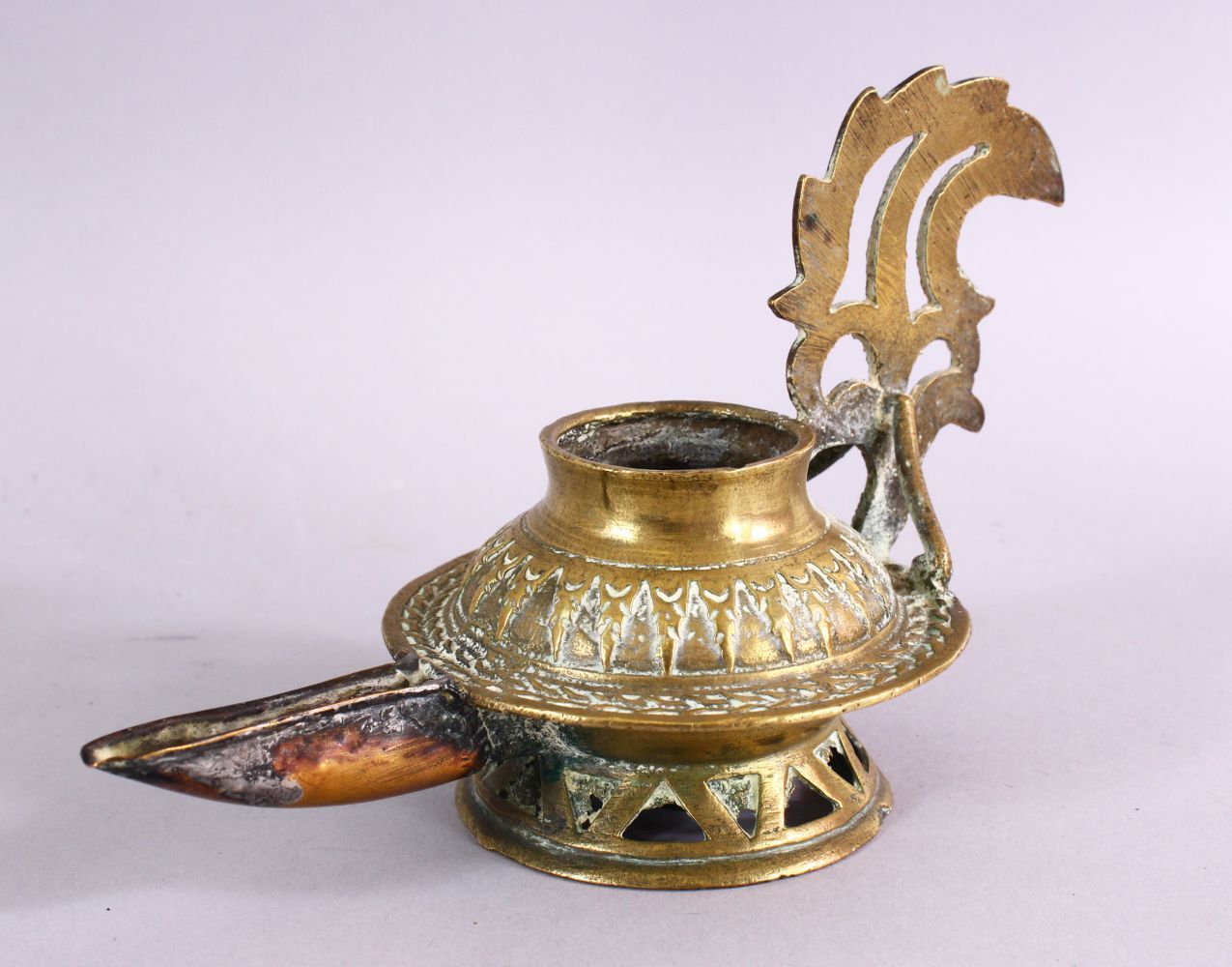 AN UNUSUAL EARLY ISLAMIC POSSIBLY ANDALUSIAN SPANISH BRASS OIL LAMP, with moulded decoration, 17cm