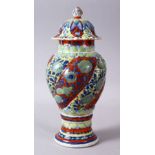 A 19TH / 20TH CENTURY CHINESE KANGXI STYLE PORCELAIN RIBBED VASE AND COVER, With underglaze blue
