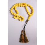 A CHINESE QING DYNASTY CARVED AMBER PRAYER BEADS / ROSARY NECKLACE, comprising 53 beads, 5 spacers