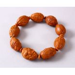 A CHINESE CARVED NUT BRACELET.