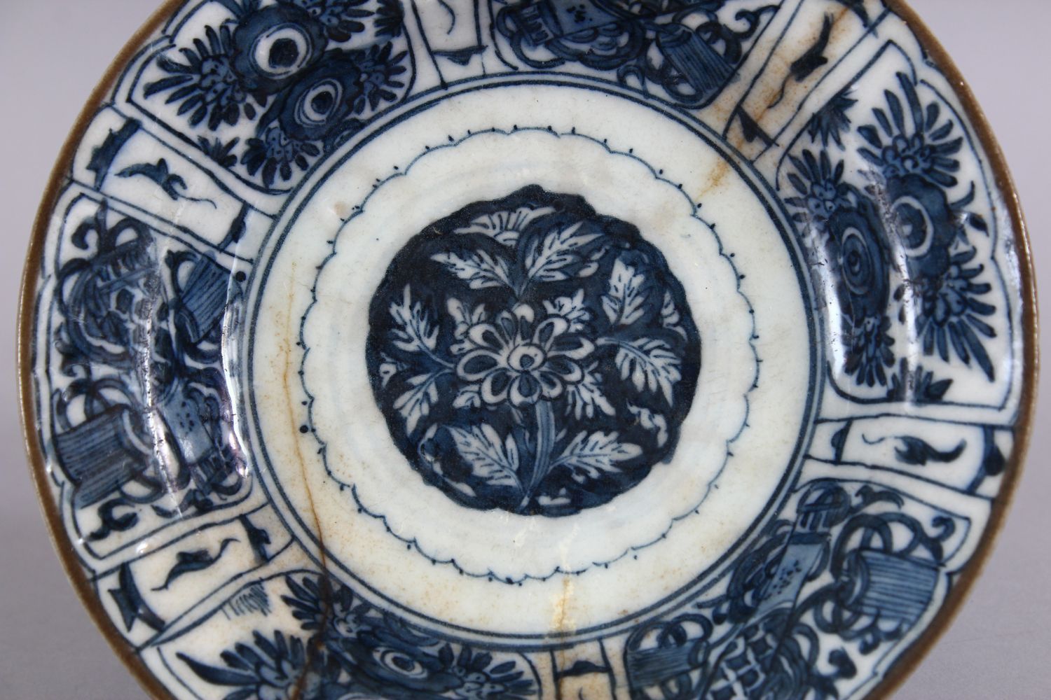 A 17TH CENTURY PERSIAN SAFAVID BLUE AND WHITE DISH, decorated with precious objects and native - Image 2 of 3