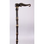 AN 18TH CENTURY MUGHAL RHINO HORN AND BONE WALKING STICK, carved in section with Rhino horn and