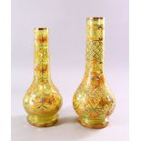 TWO 20TH CENTURY ISLAMIC GREEN GLASS HUQQA BASES / VASES, both with floral and scrollwork