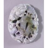 A CHINESE CARVED HARDSTONE ROUNDEL, carved with kylin and naturalistic forms, 8cm x 6cm.