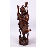 A LARGE 19TH CENTURY CHINESE CARVED HARDWOOD FIGURE OF A DEVIL, stood upon a wave formed base with