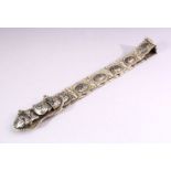 A RUSSIAN NIELLO DECORATED WHITE METAL BELT, consisting of an ornate buckle and fourteen oval