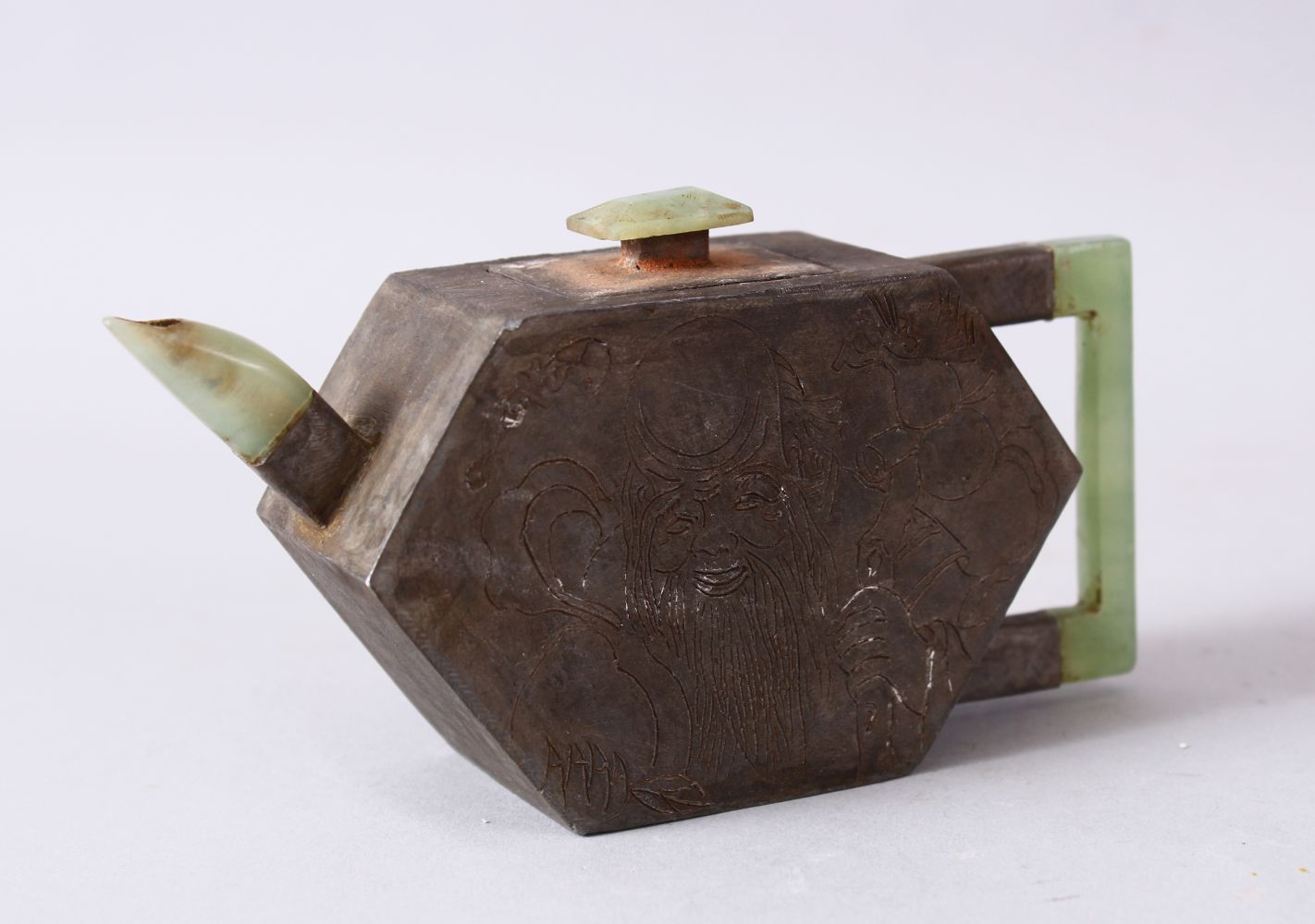 A CHINESE METAL & JADE TEAPOT, the teapot body formed from white metal and carved with scenes of