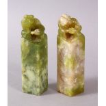 TWO GOOD CHINESE CARVED JADE OR JADE LIKE HARDSTONE LION DOG SEALS, the bases carved, the tops