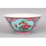 A CHINESE PINK GROUND FAMILLE ROSE PORCELAIN BOWL, with panels of native flora on a blue ground, the