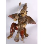 A 19TH CENTURY INDIAN / BURMESE CARVED WOOD FIGURE OF A WINGED GOD, stood holding an implement, with