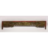 A CHINESE CARVED GILDED AND LACQUERED HEADBOARD PANEL, (AF), 190cm long, 35cm at widest point.