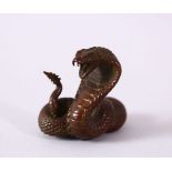 A JAPANESE BRONZE MODEL OF A COBRA SNAKE, intertwined, signed, 4.5cm.