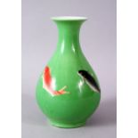 A CHINESE GREEN GLAZED VASE, painted with fish, mark in red, 15cm high.