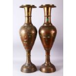 A LARGE PAIR OF 19TH/20TH CENTURY INDIAN BRASS FLOOR STANDING VASES, each with carved decoration