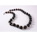 A GOOD SET OF VICTORIAN CARVED AGATE ROSARY BEADS, in mont blanc style colours, dark brown to