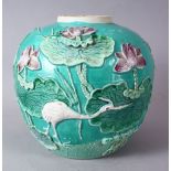 A CHINESE TURQUOISE GROUND PORCELAIN GINGER JAR, with raised relief decoration of a crane amongst