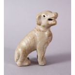 A SMALL CHINESE POTTERY SEATED DOG, 7cm high.