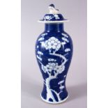 A 19TH CENTURY CHINESE BLUE & WHITE PORCELAIN PRUNUS VASE & COVER, the body decorated with prunus