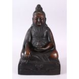 A CHINESE BRONZE CAST FIGURE OF DEITY OR BUDDHA, in a seated position holding a vessel in
