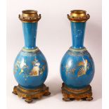 A PAIR OF 19TH CENTURY CHINESE PORCELAIN BOTTLE VASES / LAMP BASES, the ground with gilded