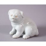 A 19TH CENTURY JAPANESE HIRADO PORCELAIN MODEL OF A PUPPY in a seated pose, 10cm high, 13cm wide.