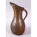 A 19TH CENTURY PERSIAN COPPER JUG, engraved with boteh.