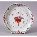 AN 18TH CENTURY CHINESE FAMILLE ROSE CIRCULAR SHAPED SPOON TRAY, painted with a basket of flowers,